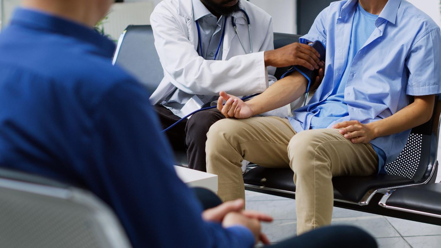 A doctor measuring a patient's blood pressure.